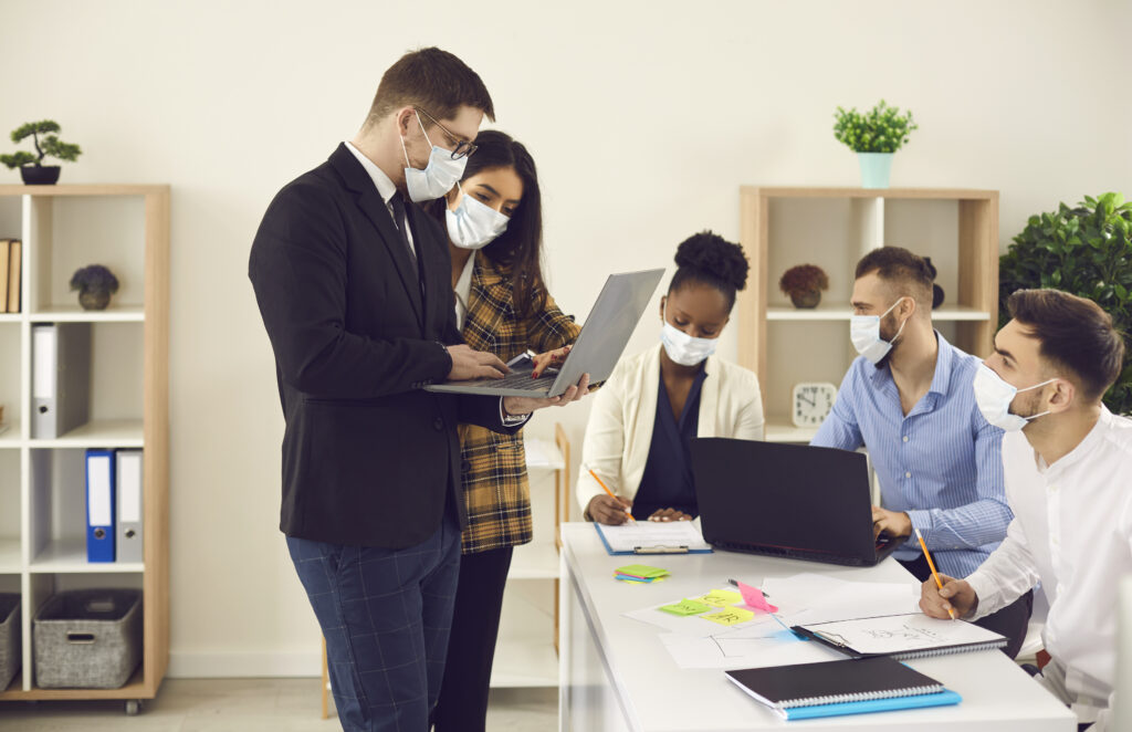 people wearing masks in an office setting