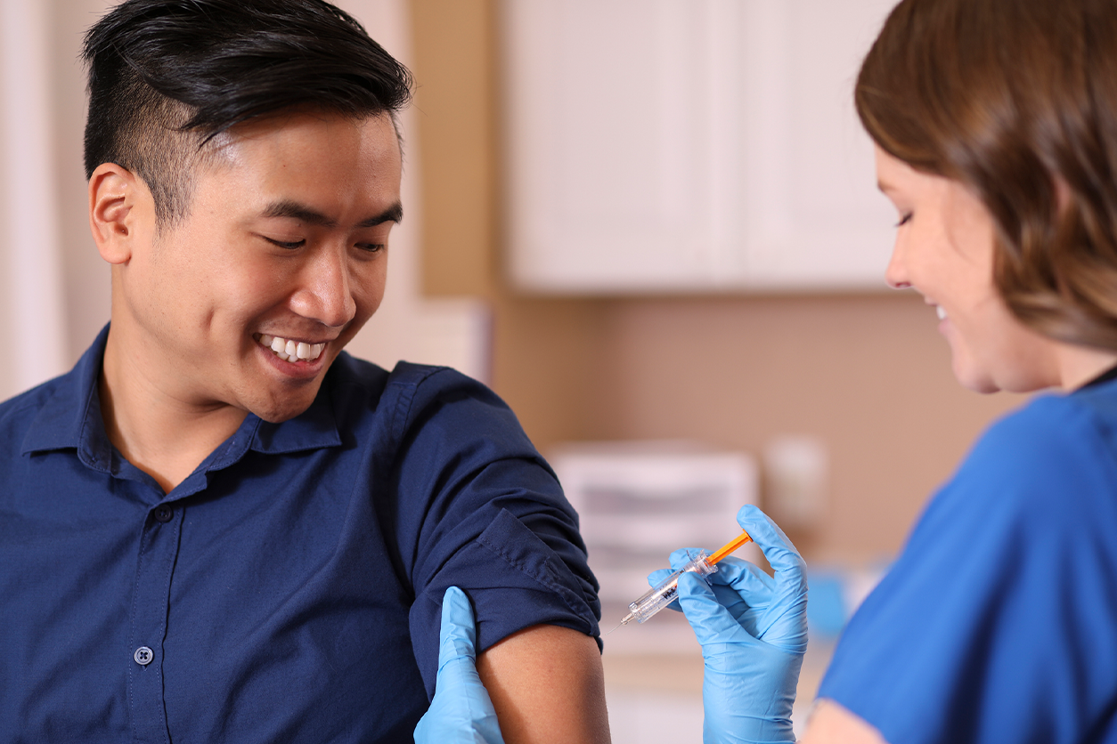 Image of someone getting vaccinated by a healthcare worker